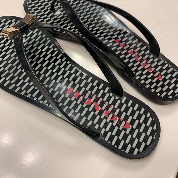Coach Shoes - Coach jelly navy flip flop w/gold bow!